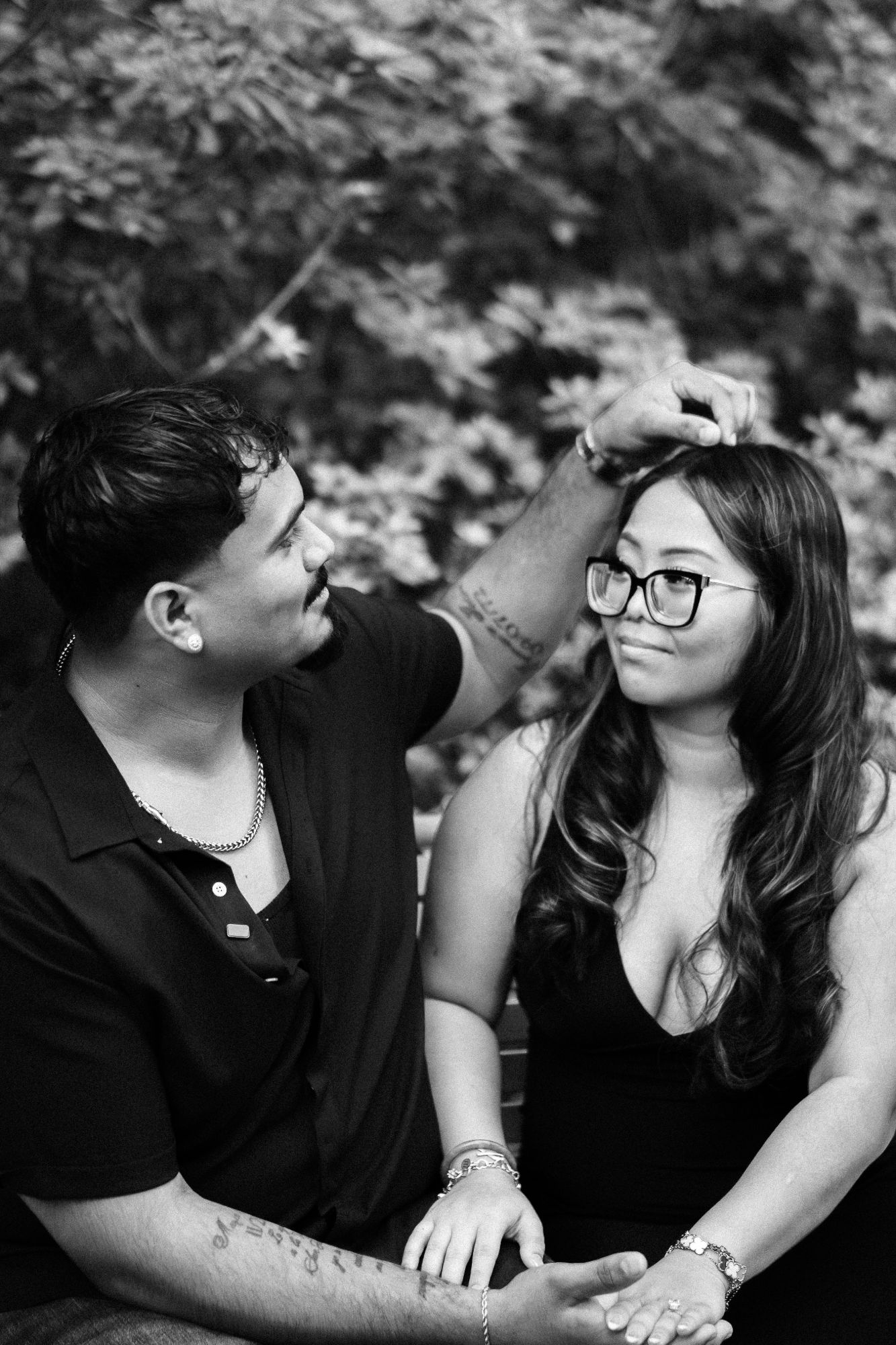 Black and white portrait of a newly engaged couple sitting together after their proposal