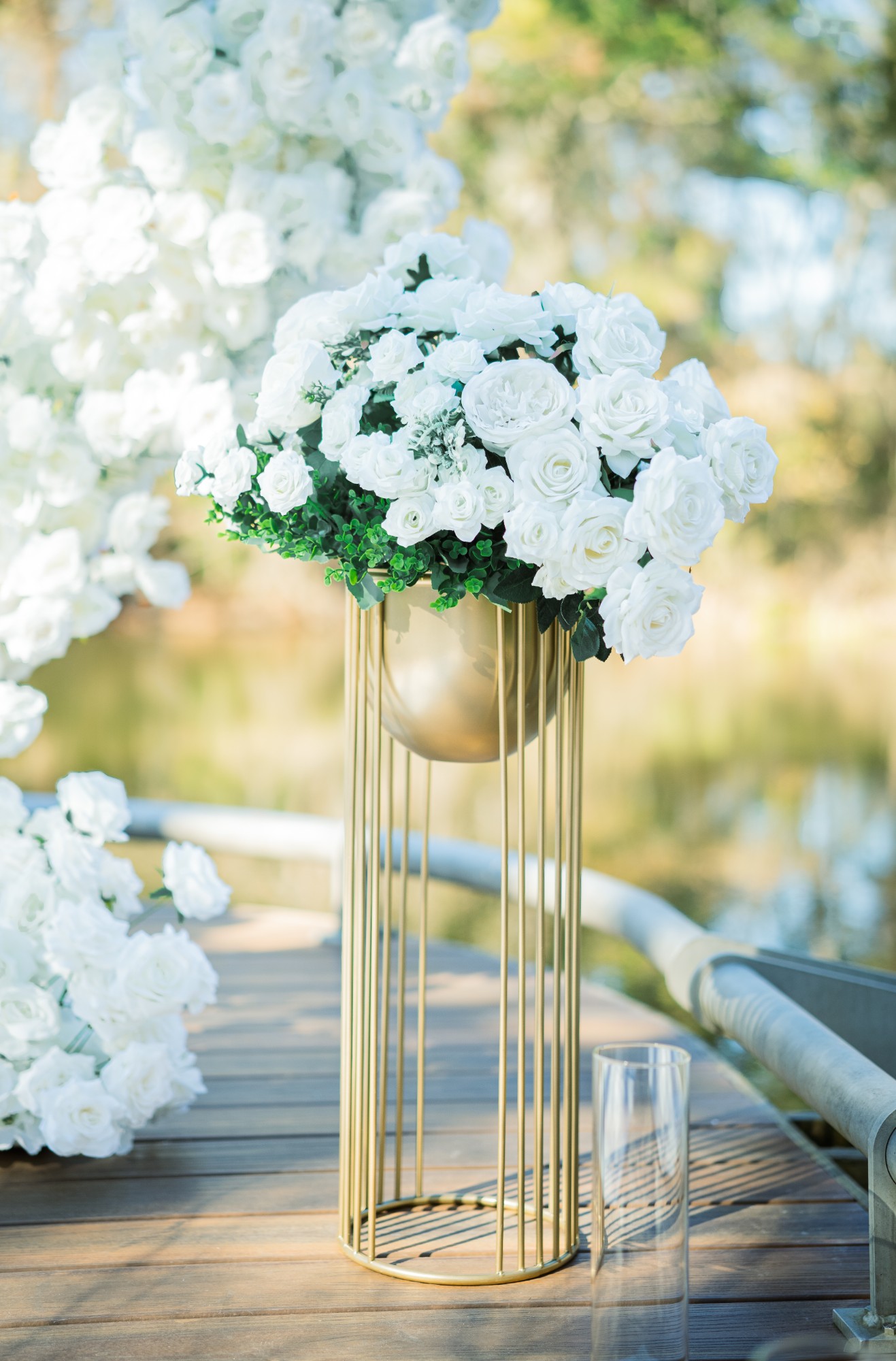 White rose arrangement on a gold floral pedestal at a proposal setup in Houston